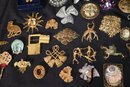 this large collection of vintage mostly gold tone pins and brooches comes in a variety of styles and sizes.
